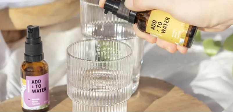 ADD TO WATER product beside a glass of water