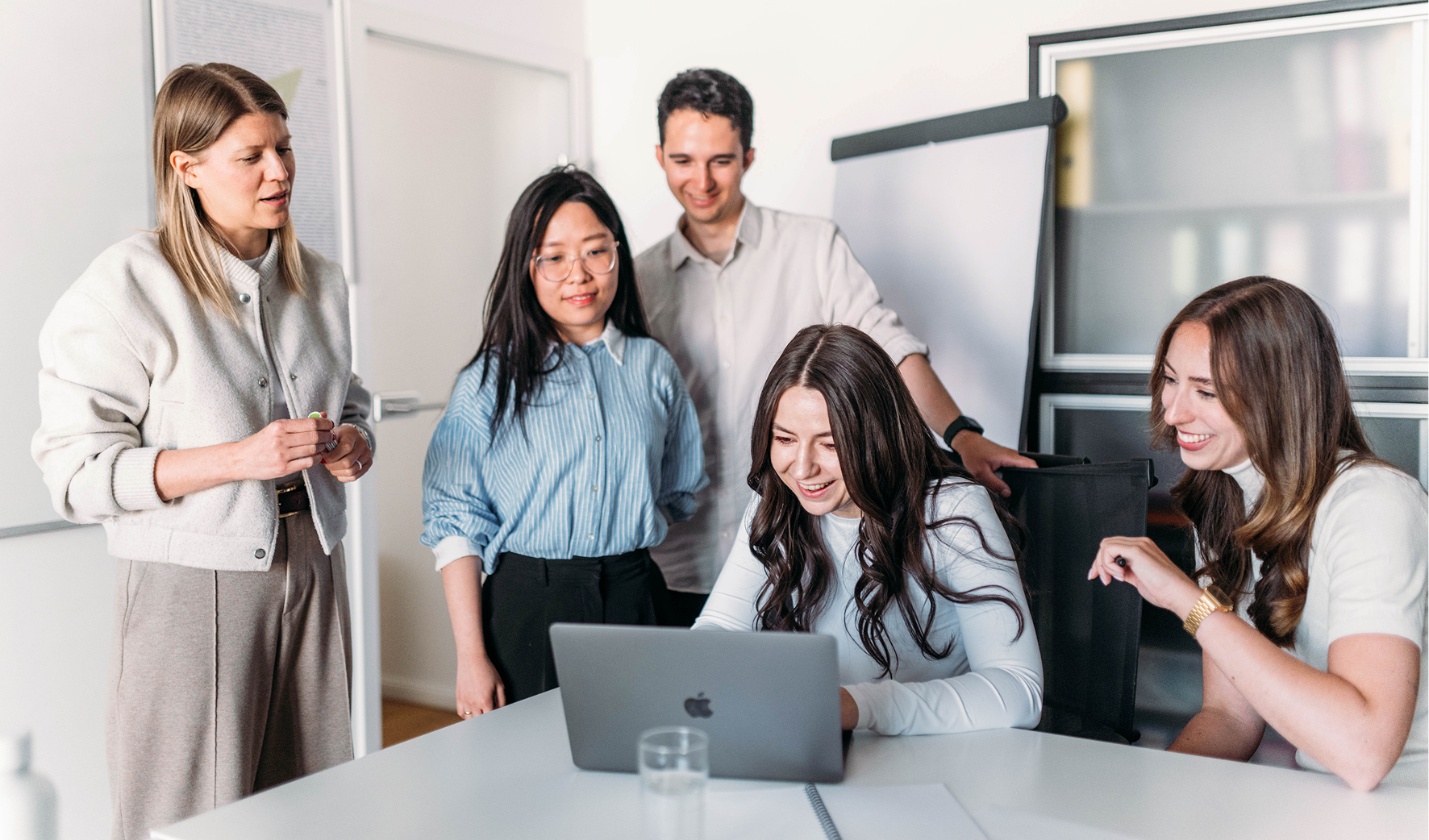 TheVentury team collaborating around a laptop